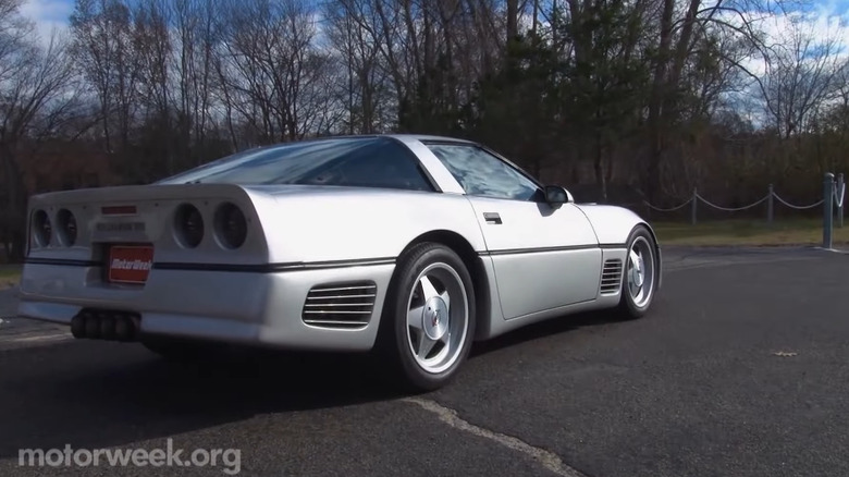 The silver Callaway Sledgehammer standing in a parking lot, seen from the rear