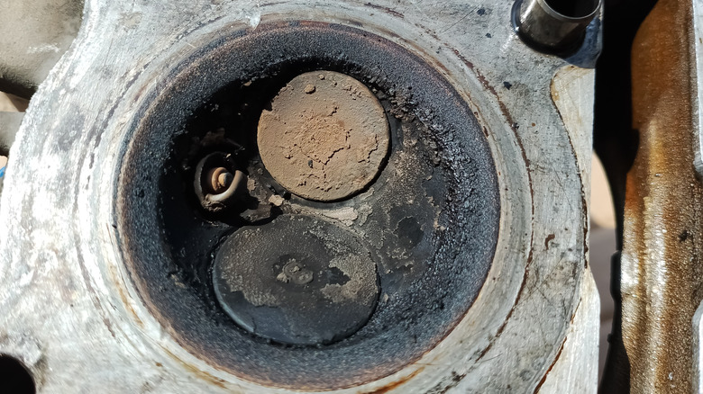 Dirty intake and exhaust valves shown in engine cylinder head