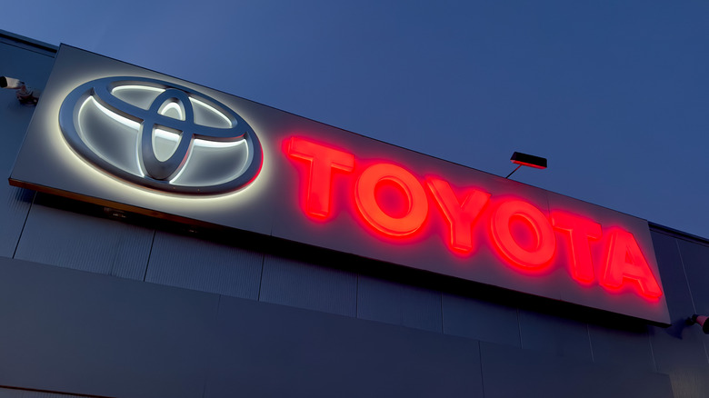 The neon-lit sign of a Toyota dealership in London, UK
