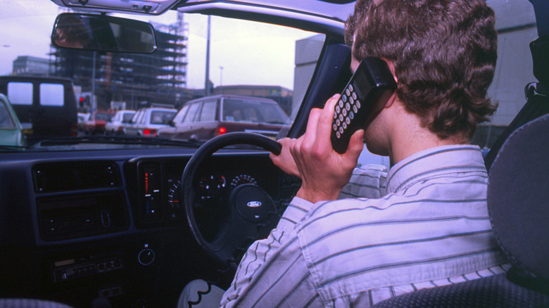 Driver using a car phone in traffic.