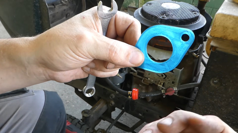 A 3D printed gasket in front of an engine