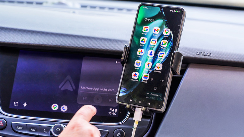 A German motorist attempts to use a smartphone with Android Auto in an Opel