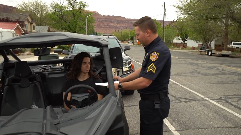 A police officer pulling over a person in a UTV