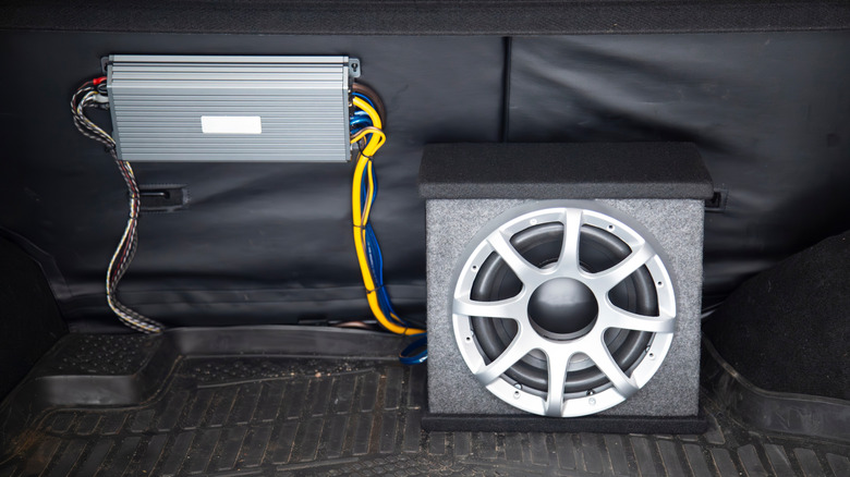 An aftermarket amplifier and subwoofer installed in a vehicle