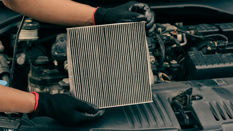 Mechanic holding a dirty air filter