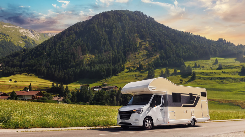 An RV in front of a picturesque mountain