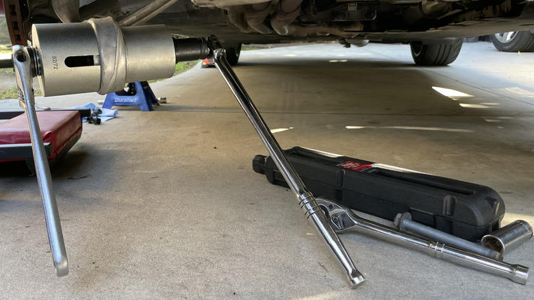 Tools attached to a front suspension bushing from a BMW 1 Series.