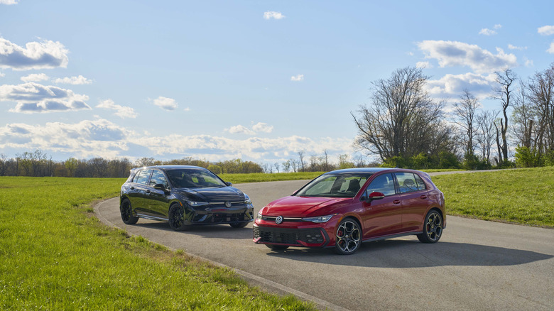 2025 Volkswagen Golf R Black Edition (left) and Volkswagen Golf GTI Autobahn Edition (right) parked in a curve