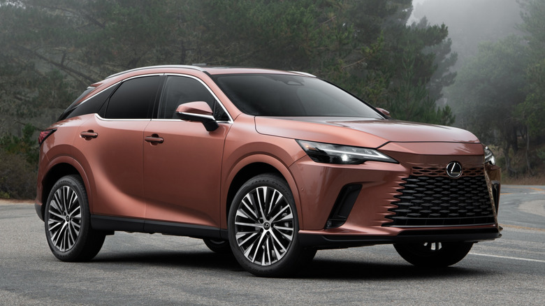 Front 3/4 view of a copper-colored 2026 Lexus RX 350 Premium AWD parked on a coastal mountain road.
