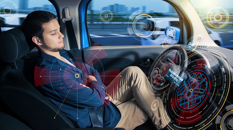 A driver asleep at the wheel of a car in autonomous driving mode