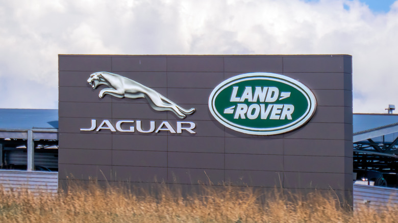 Calgary, Alberta, Canada. Jun 5, 2025. The iconic Jaguar and Land Rover logos are prominently displayed on a modern building, signifying luxury automotive excellence and British heritage.