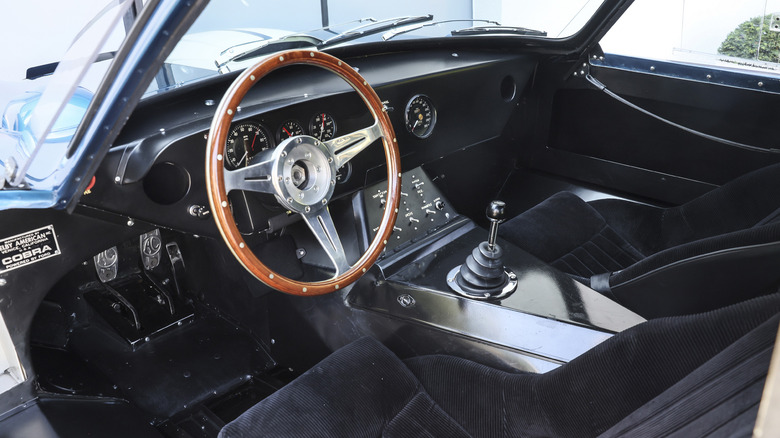 Mostly empty interior of a 1964 Shelby Cobra Daytona coupe with a Moto-Lita steering wheel.