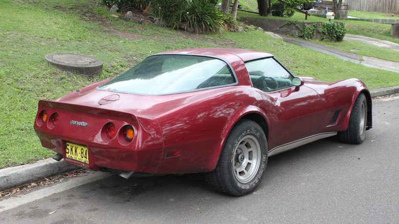 A burgundy C3 Corvette