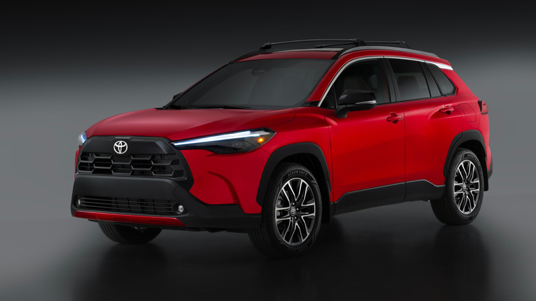 Red 2026 Toyota Corolla Cross SUV left front quarter view in studio
