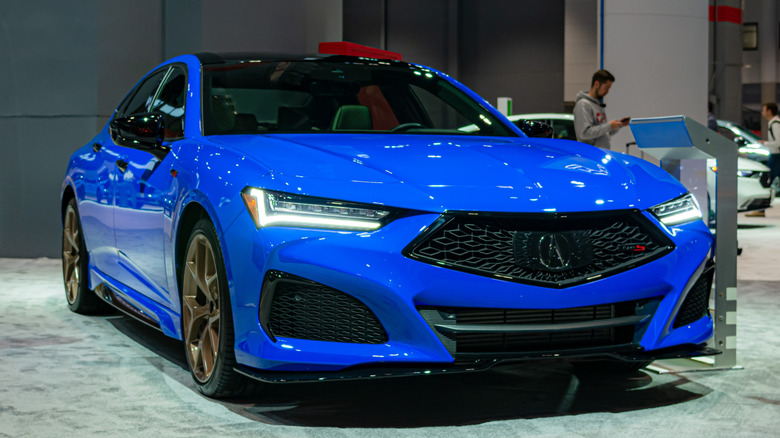 A blue Acura TLX Type S is displayed at an auto show.