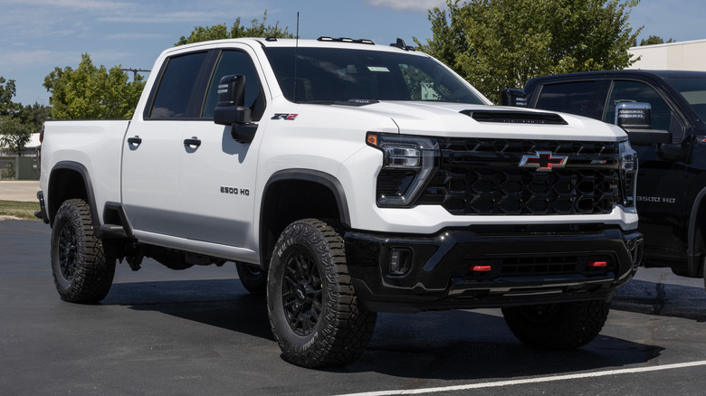 A white GMC Sierra 2500 Crew Cab sits parked.