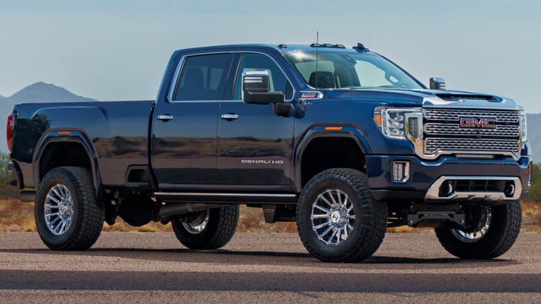 A blue GMC Sierra 3500 Crew Cab sits parked.