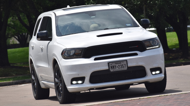 A white Dodge Durango sits parked.