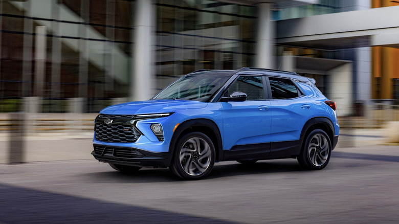 A blue Chevy Blazer driving through downtown