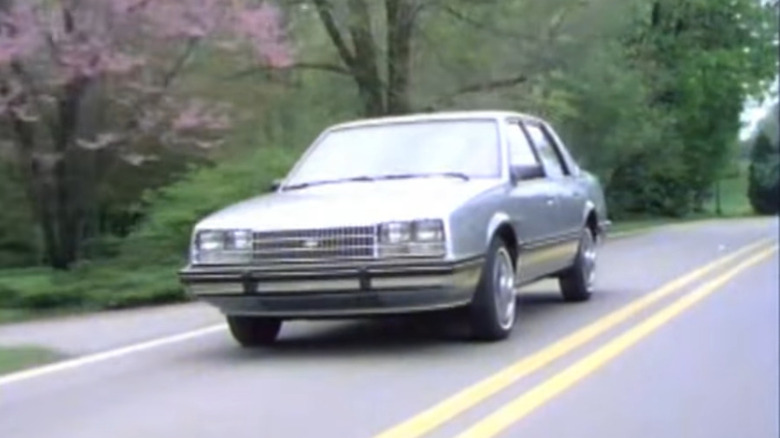 A 1985 Chevrolet Celebrity driving on a road