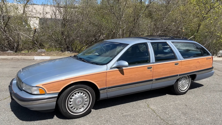 A silver 1994 Buick Roadmaster Estate with wood panels on a parking lot