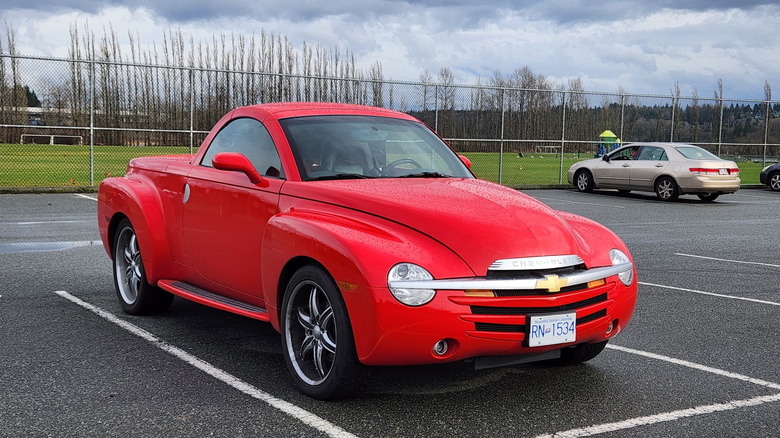 A reddish Chevrolet SSR connected a parking batch pinch a shot section successful nan background