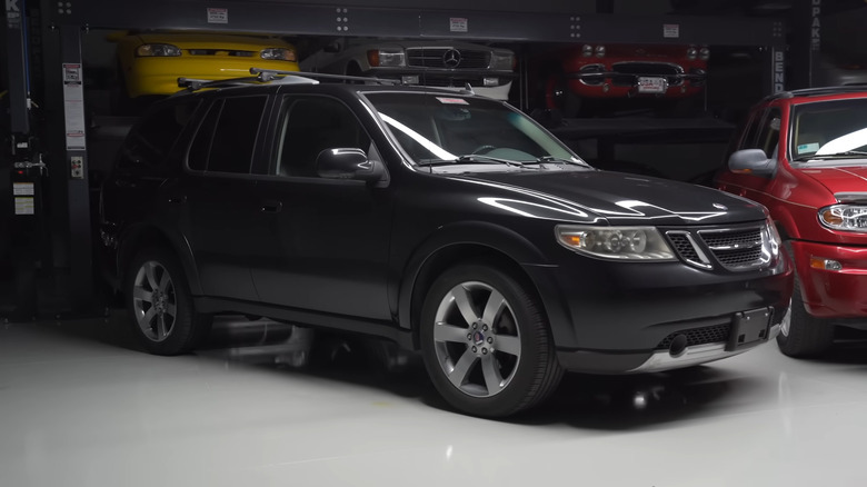 A black Saab 9-7X Aero in a garage
