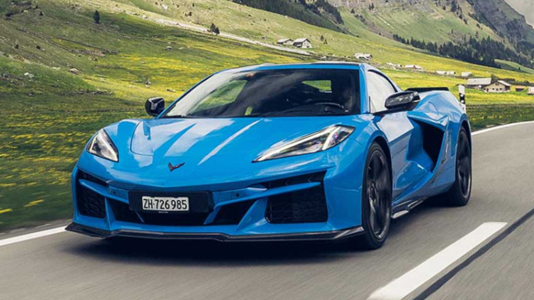 A blue Chevrolet Corvette E-Ray tearing through snow.