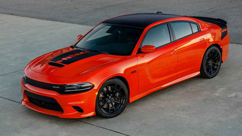 An orange Dodge Charger Daytona parked on concrete