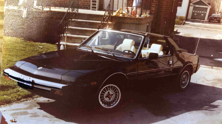 A black Fiat X1/9 sitting in a driveway somewhere in Canada