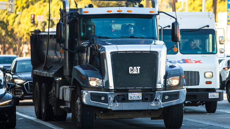 A Caterpillar CT660 dump truck in traffic.
