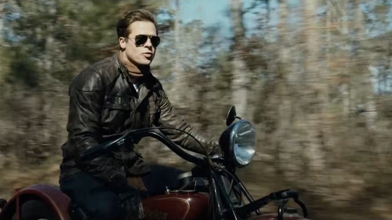 Brad Pitt riding a bike down a forest road in "The Curious Case Of Benjamin Button"
