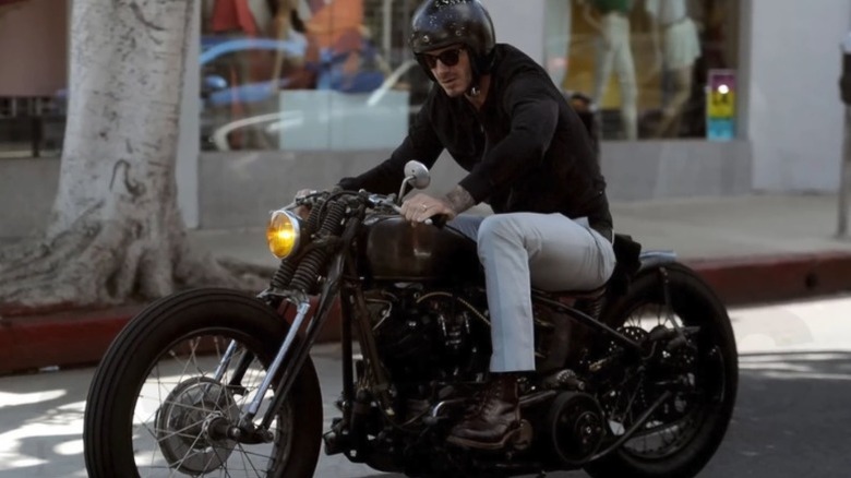 David Beckham riding a bike down a street