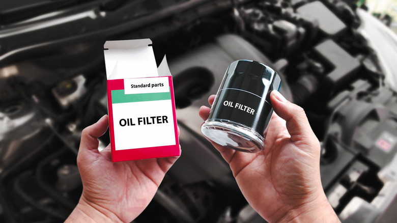 Mechanic unpacking a new oil filter from the box