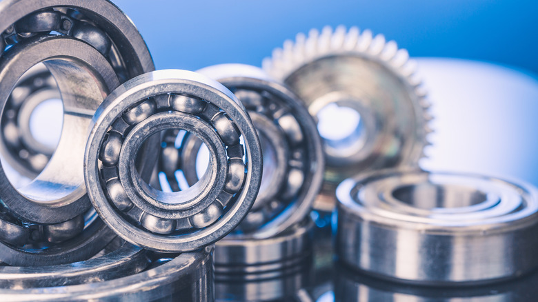 A closeup shot of ball bearings in a pile on a blue background