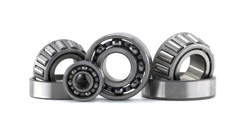 Various types of bearings are displayed in a clean, well-lit studio shot against a bright white background.