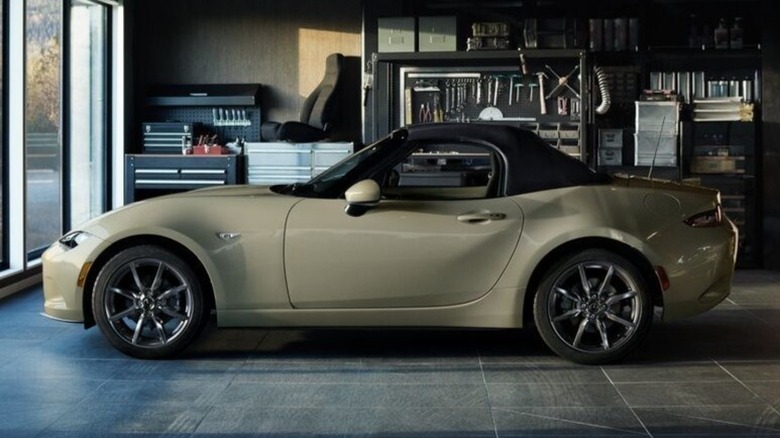 A cream 2023 Mazda MX-5 Miata in a modern garae