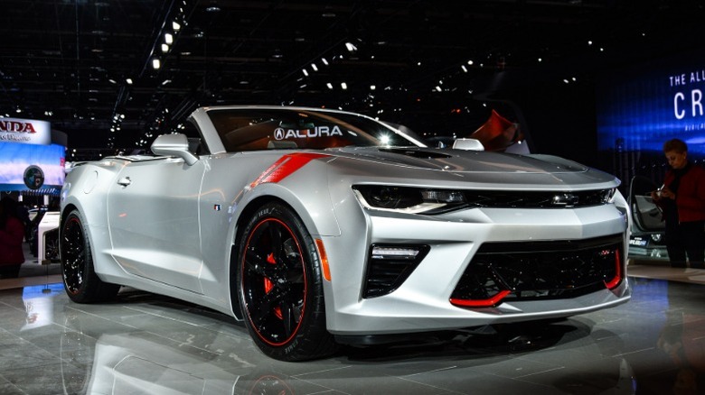 A silver 2016 Chevrolet Camaro SS on display at a car show.