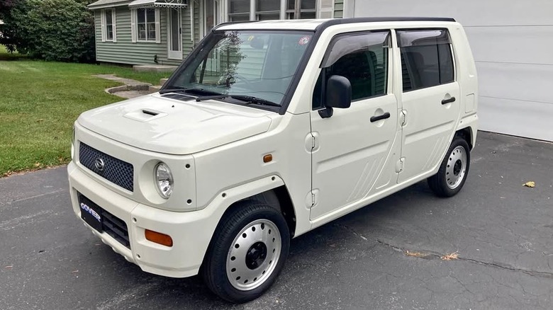 A white Daihatsu hatchback
