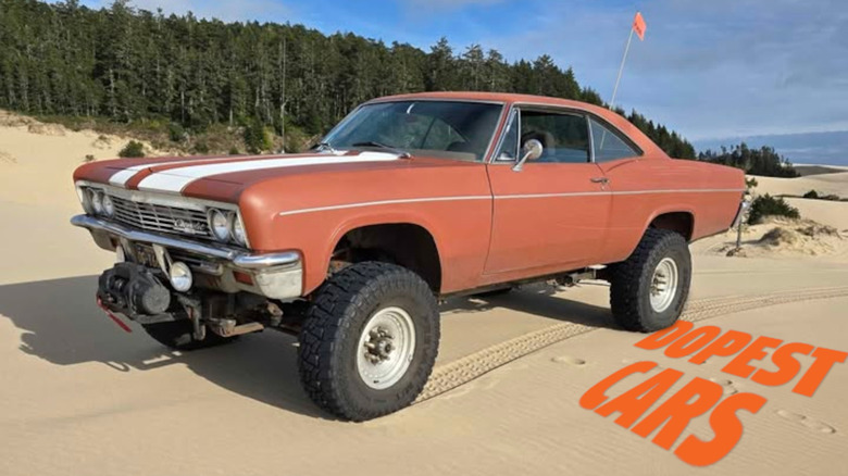 A lifted 1966 Chevy Impala on sand