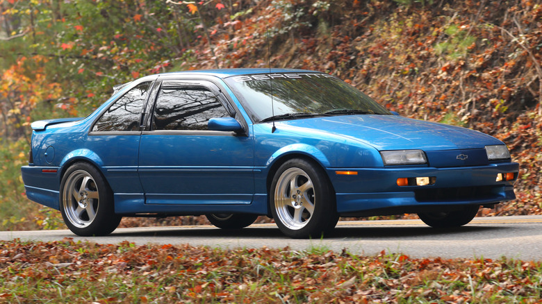 A Medium Quasar Metallic blue 1993 Chevrolet Beretta GTZ on a road in fall