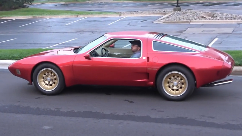 A red Chevrolet Corvette XP-897 GT Two-Rotor concept car with someone inside
