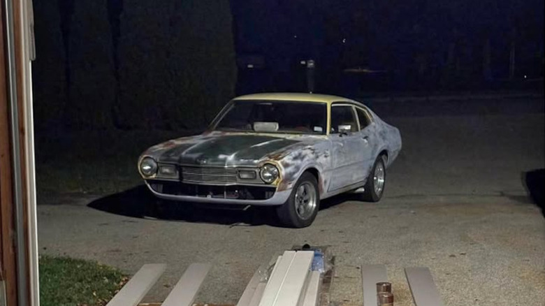 A rusted, multicolor, and primer Mercury Comet