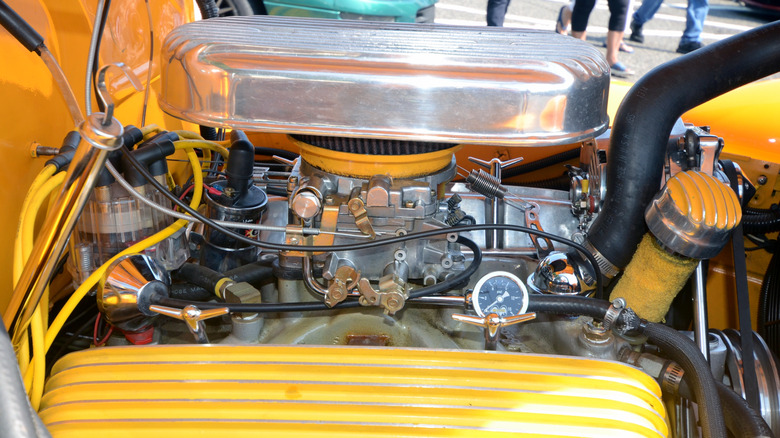 A customized 283 small block Chevrolet V8 engine on display at a car show.