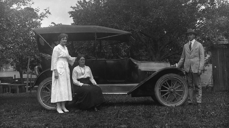 Jennie, Florentina, and Edgar Krueger posing next to a 1917 Chevrolet touring car on the Krueger farm