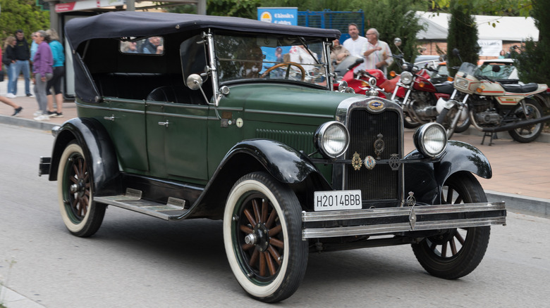 Front view of an old green Chevrolet Series AD historic car driving down the street