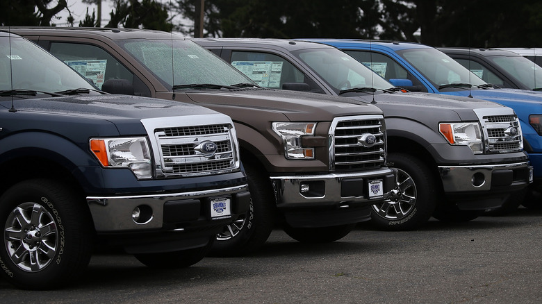 COLMA, CA - APRIL 28: New Ford F-150 pickups are displayed on the sales lot at Serramonte Ford on April 28, 2015 in Colma, California. Ford Motor Co. reported a 6.6 percent drop in first quarter earnings with net income of $924 million, or 23 cents a share, compared to $989 million, or 24 cents, one year ago. A higer than expecte tax rate and factory retooling to accomodate the new aluminum-bodied F-150 pickup contributed to the quarterly decline. The F-Series pickups accounts for 90 percent of Ford's global automotive profits.
