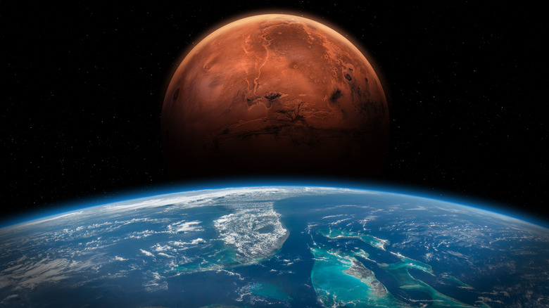 Artist's rendering of Mars looming over the Earth