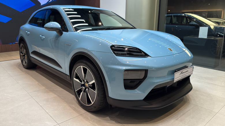 Blue Porsche Macan Electric SUV on display at Porsche showroom Bangkok.