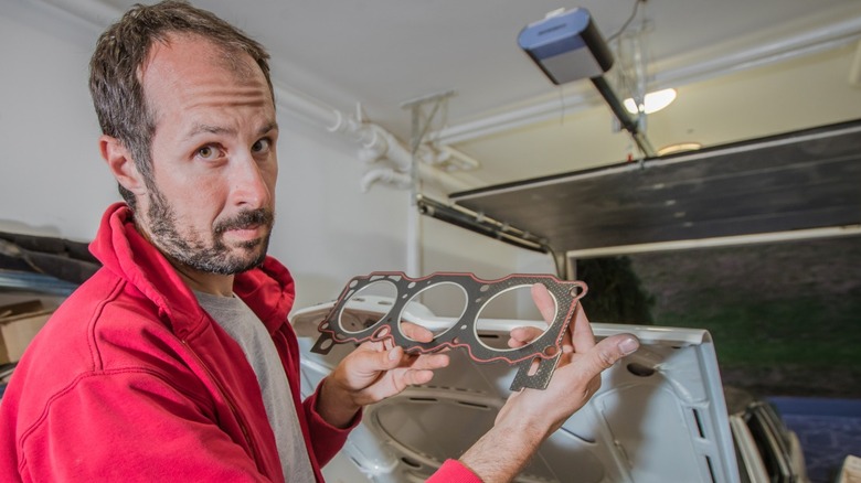 Mechanic holding head gasket